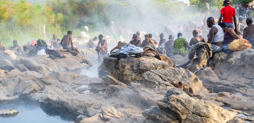 Community of people steam bathing at one of the hot springs