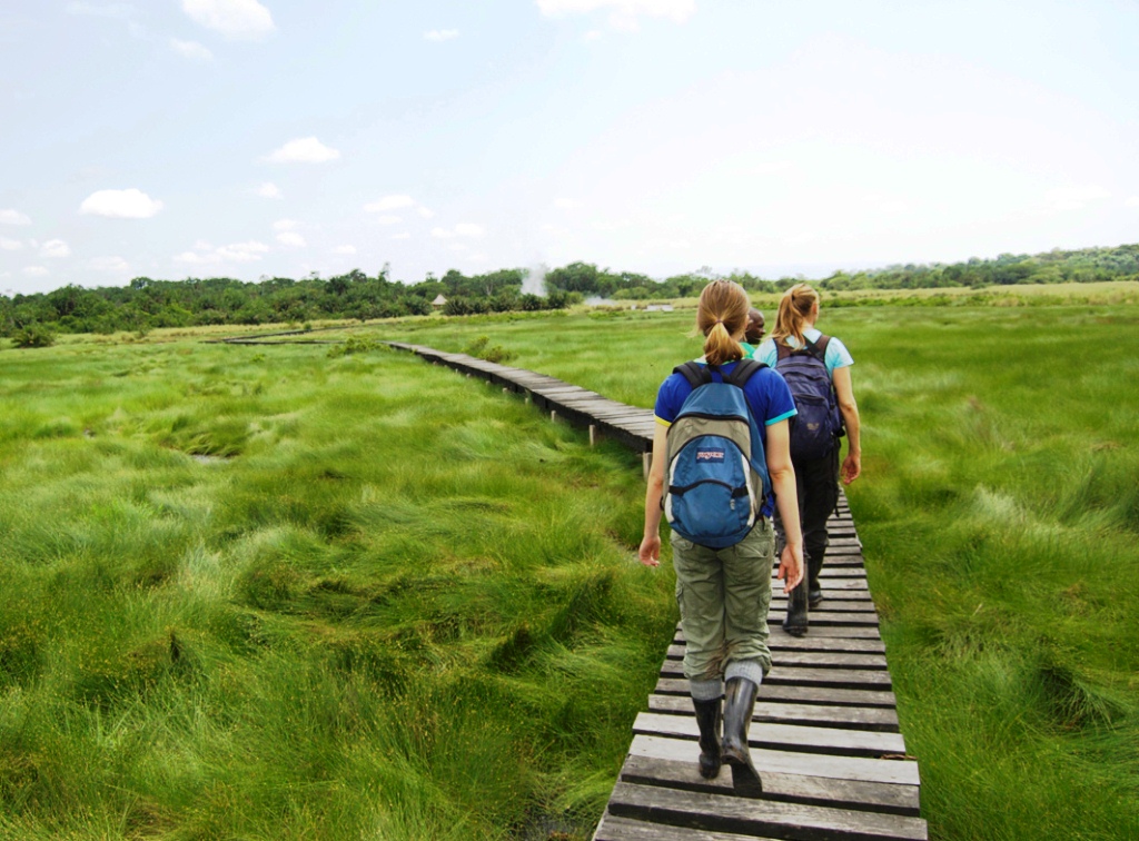 Guests on a walking trail to Sempaya hot springs one of the activities that require visitation fees in Semuliki National Park, Uganda